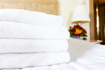Obraz na płótnie Canvas Fresh white towel pile in the upscale hotel room. Being alone, getaway, staycation, digital detox, trip, vacation concepts. Horizontal
