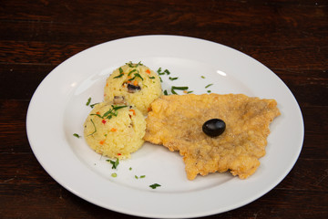 Chicken breast schnitzel with rice and olives