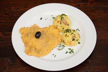 Chicken breast schnitzel with rice and olives