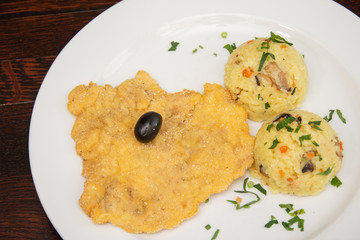 Chicken breast schnitzel with rice and olives