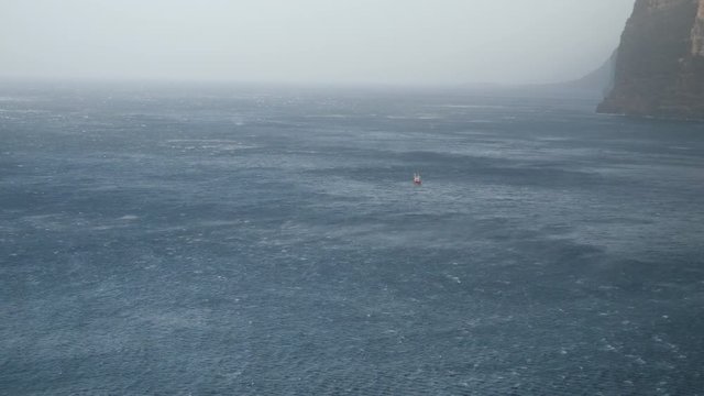Ship stranded in Sandstorm Calima Tenerife ocean. Boat adrift in Canary Islands. African Sahara dust sand storm. Time lapse Spain 23 FEB 2020