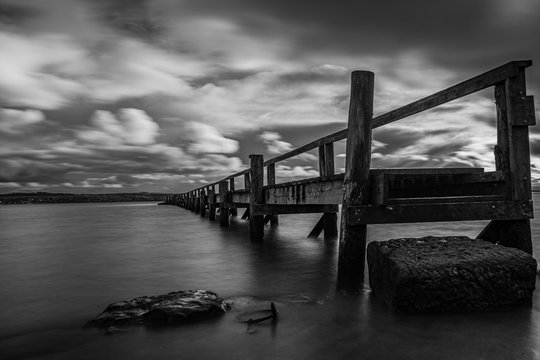 black and white image of culross pier, fife, scotland, uk.