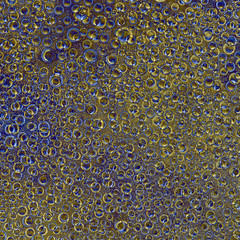 Pattern of randomly interwoven rings and balls of different diameters and blue, cyan and gold...
