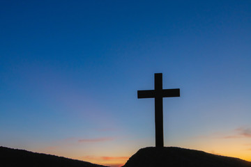 The silhouette of the crucifixion of Jesus Christ - crossing at sunset