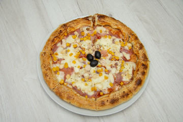 Pizza with corn and ham and sesame