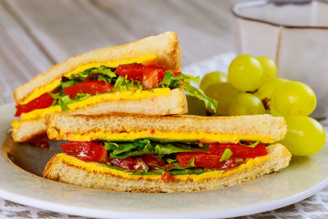 Healty grilled cheese sandwich with vegetable and grape.