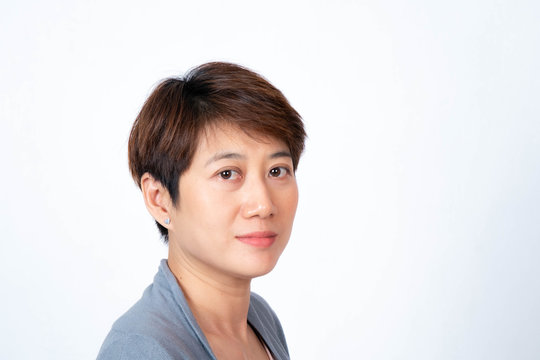 Portrait of short-haired Asian woman smiling side-facing On a white background