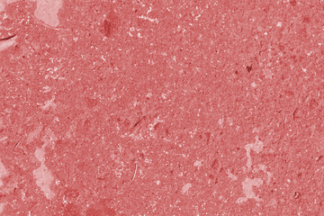 Fototapeta premium Old asphalt surface close up. Abstract background red color toned