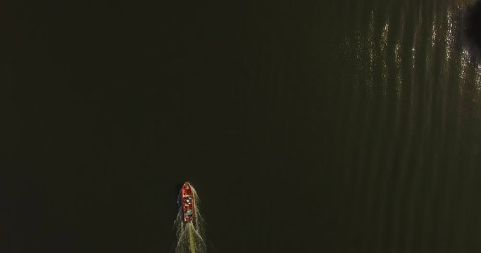 From the top view of a small red fishing boat cruising the Higuerote canals in Venezuela