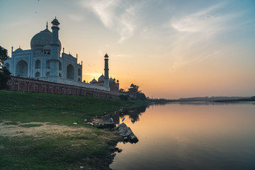 taj mahal at sunset with river and white pink marble seven wonder world