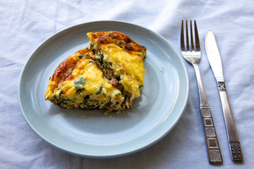 Frittata made of eggs, bacon, cheese and spinach