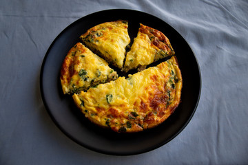 Frittata made of eggs, bacon, cheese and spinach