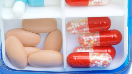 medical capsules with granules inside in a box for daily use close-up.