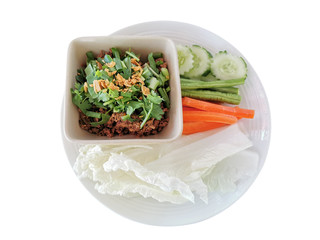 Food of Northern Thailand , Spicy Minced Pork Salad on top Fry the garlic, coriander And cucumber, yard long beans, carrots on a white plate