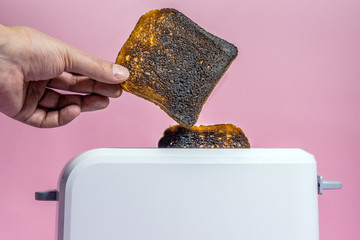 burnt bread in the toaster close-up. making toast