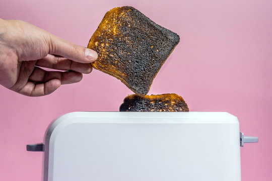burnt bread in the toaster close-up. making toast