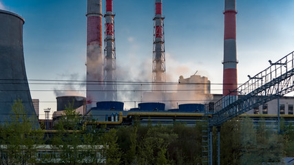 Fototapeta na wymiar Combined heat and power plant at light of sunset