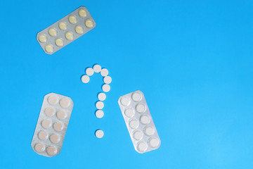 tablets on a blue background, a choice of medications for treatment. medical concept