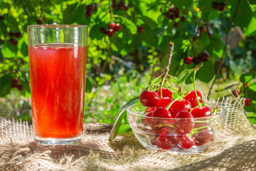 Homemade fresh cherry juice of ripe berries in a glass. The Rustic style.Healthy and diet food. Selective focus