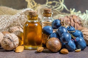 bottle of aroma oil, nuts. Set of organic cosmetic products, selective focus. Spa, massage, female treatment, aromatherapy, body care, authentic raw material