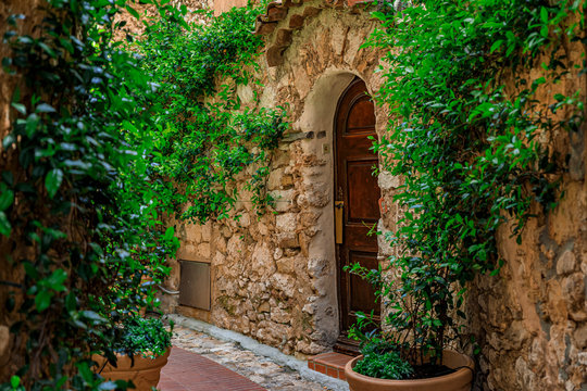 Fototapeta Old buildings on narrow streets in the medieval city of Eze Village in the South of France along the Mediterranean Sea
