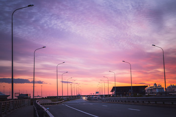 Modern cruise liner in the harbour in the evening with striped sky and water