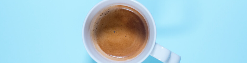Fresh cup cappuccino coffee milk on pastel blue