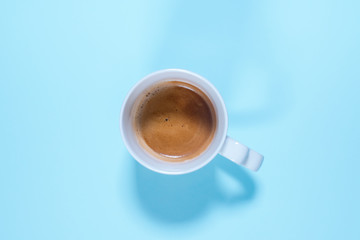 Fresh cup cappuccino coffee milk on pastel blue