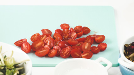 Preparation of vegetable salad. Tomatoes on a cutting board.