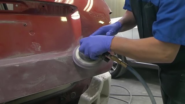 Mechanic Sanding Car for Body work at shop Auto Repair Collision
