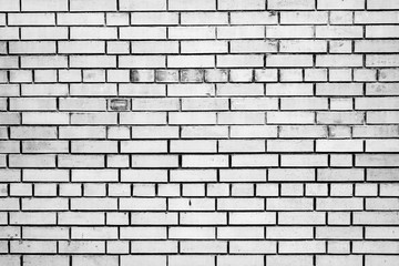 Fototapeta premium Texture of a brick wall with cracks and scratches which can be used as a background