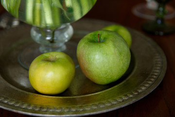 green apples on a metal tray on the table