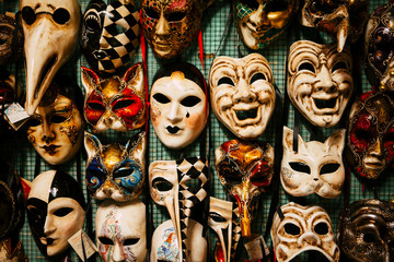 Close up view of colorful male and female carnival masks hand-painted by Italian craftsmen in a...
