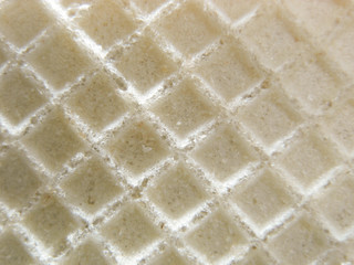 Waffle background close-up. Crispy macro waffle. Confectionery. Abstract background.
