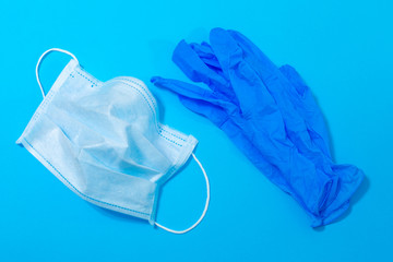 medical mask and gloves on a blue background