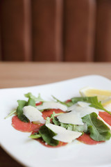 Beef Carpaccio cold appetizer with parmesan cheese italian food