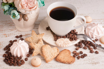cup of coffee and cookies on wooden table