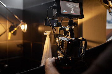 Video production backstage. Behind the scenes of creating video content, a professional team of...