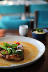 Grilled Porkchop and vegetables on top on wood background