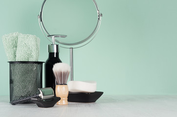 Elegant bathroom decor with black accessories for shave - razor, mirror, soap, cotton towel,...