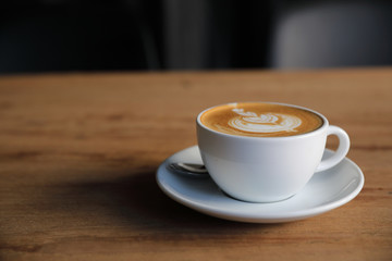 cappuccino or Latte art coffee made from milk on the wood table in coffee shop