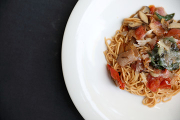 spaghetti Bolognese with minced beef and tomato sauce garnished with parmesan cheese and basil , Italian food