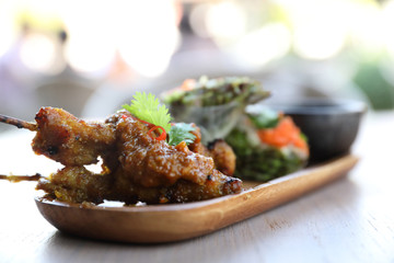 Chicken Satay on wood background