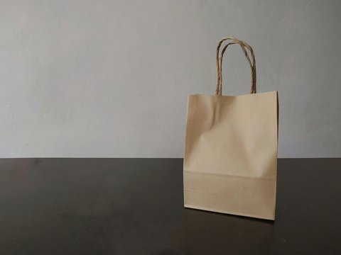 Brown Paper Shopping Bag Placed On A Wooden Table