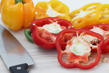 peppers on the kitchen cutting board in a white background.