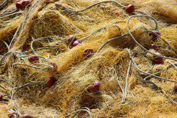 close-up of a tangled yellow old fishing net any fisherman’s essential equipment for fishing on...