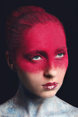 Beautiful woman with unusual makeup on dark background