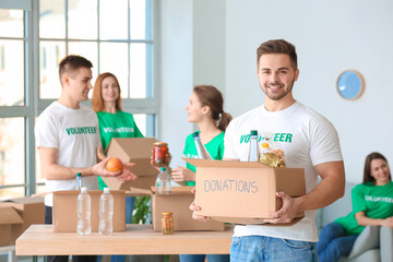 Team of volunteers with products indoors
