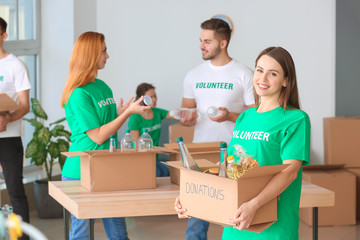 Team of volunteers with products indoors
