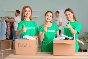 Volunteers with donations for poor people indoors